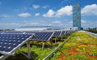 The roof vegetation provides for a cooler ambient temperature and, as a result, for a greater yield from the PV system. Green roof in combination with photovoltaics